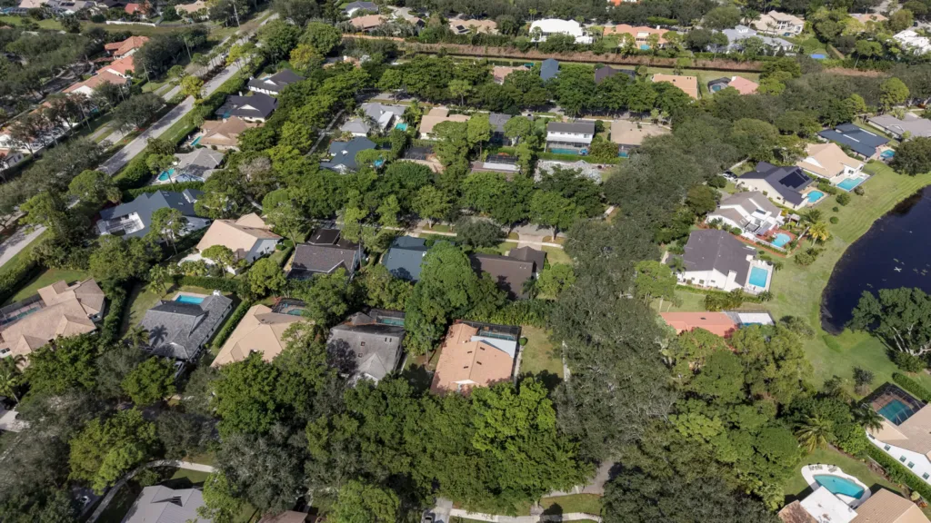 Homes with backyard pools surrounded by trees in the Millpond neighborhood of Boca Raton