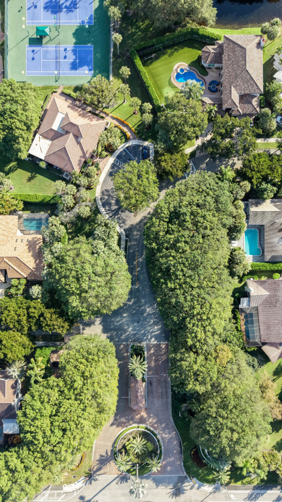 Aerial view of Parkside entrance corridor with tennis and pickleball courts nearby in Boca Raton