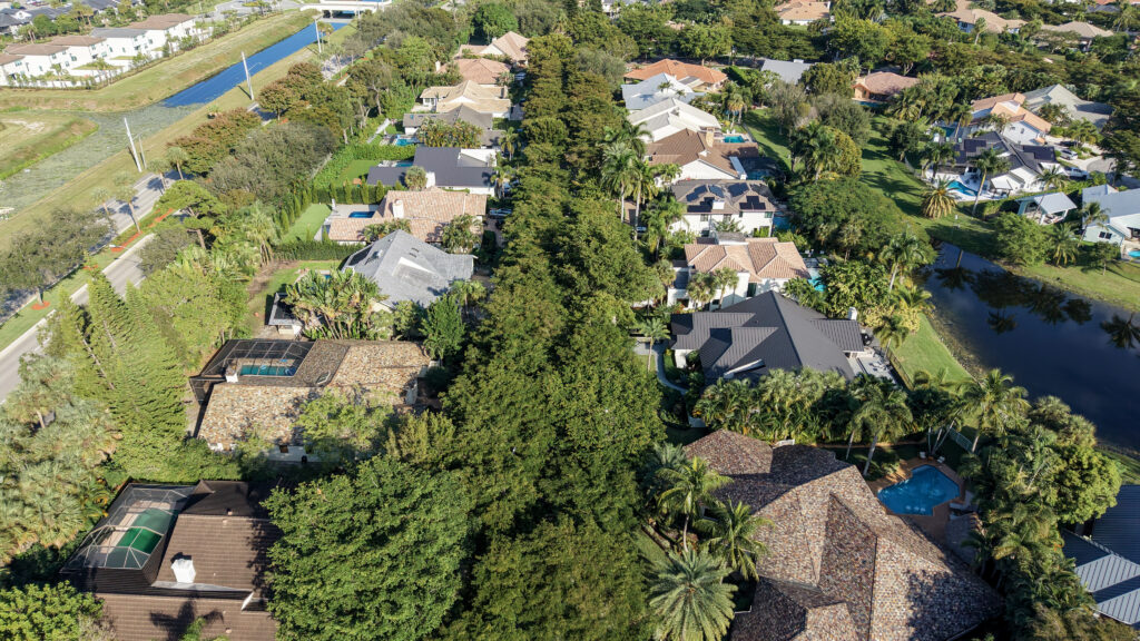 Aerial of Parkside tree canopy street near the neighborhood edge in Boca Raton